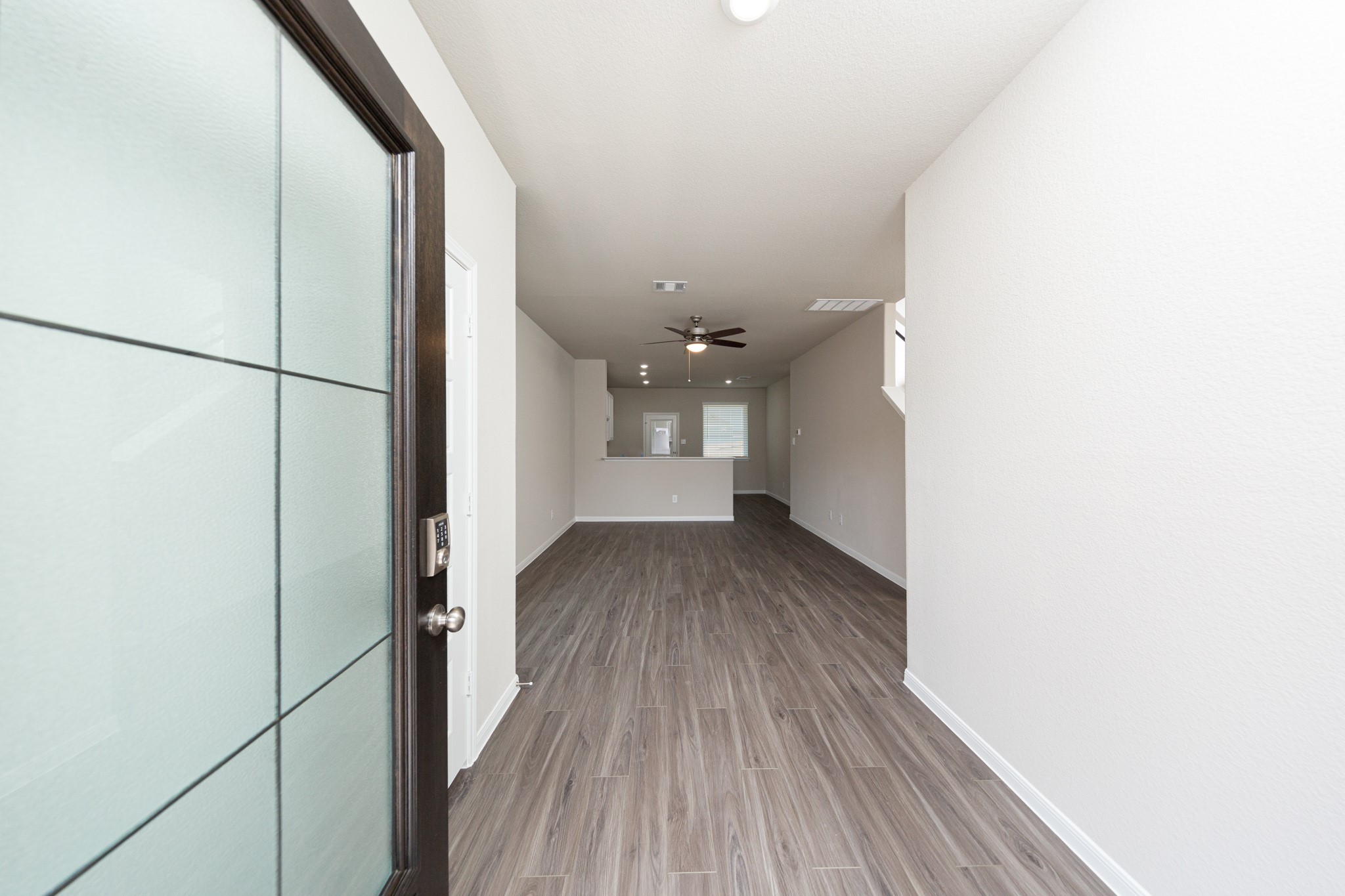 9258 Grace Rdg Drive Willis, TX 77318 - Photo 4 of 24 a view of a hallway with wooden floor