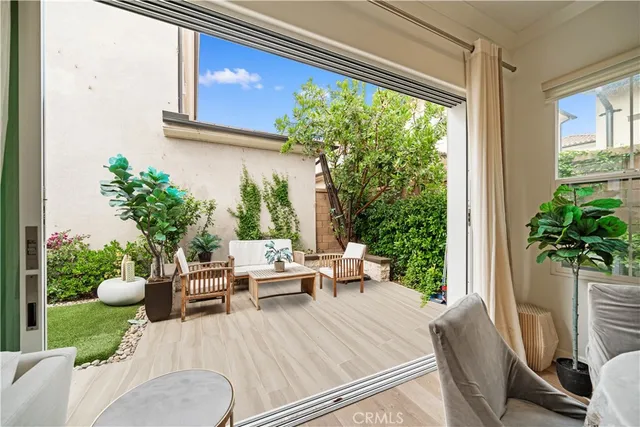 a view of a patio with couches chairs and potted plants