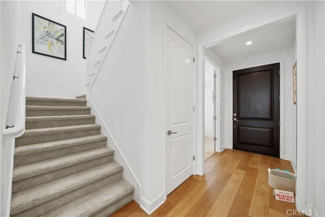 a view of a hallway with wooden floor and entryway