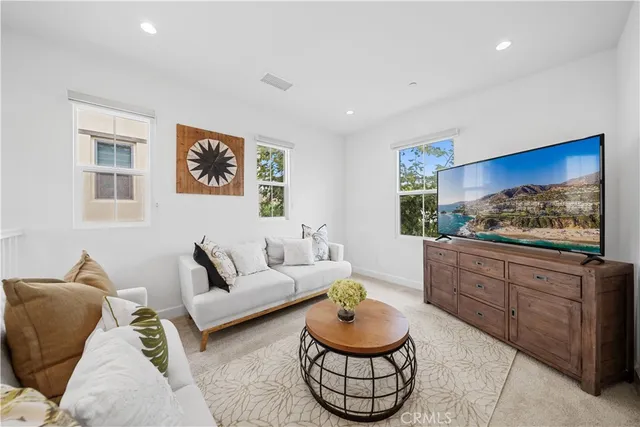 a living room with furniture and a painting on the wall
