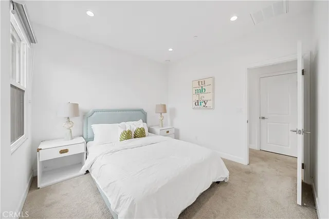 a bedroom with a bed and a lamp