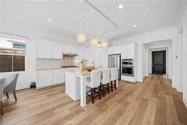a kitchen with stainless steel appliances kitchen island granite countertop a sink and cabinets