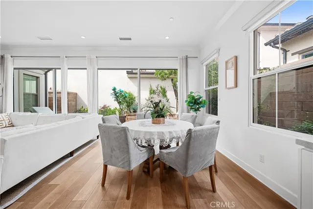 a view of a dining room with furniture large windows and wooden floor