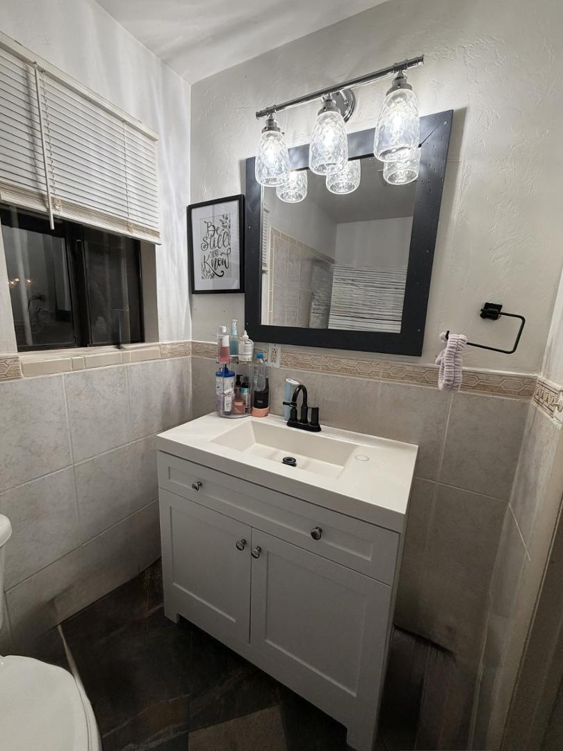 1522 East 9th Street Douglas, AZ 85607 - Photo 13 of 13 a bathroom with a sink mirror and toilet