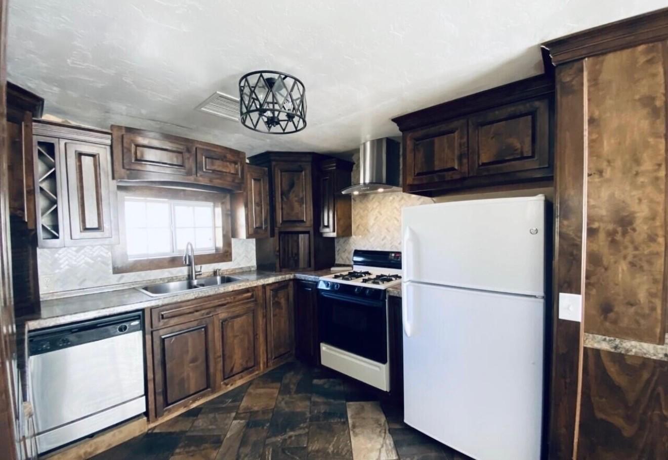 1522 East 9th Street Douglas, AZ 85607 - Photo 2 of 13 a kitchen with a refrigerator a stove a microwave and cabinets