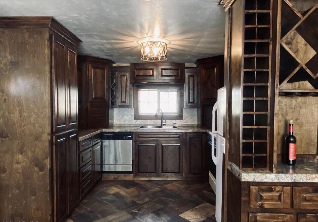 1522 East 9th Street Douglas, AZ 85607 - Photo 4 of 13 a kitchen with cabinets and stainless steel appliances