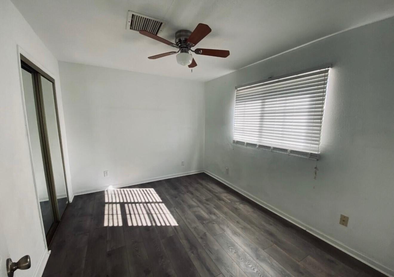 1522 East 9th Street Douglas, AZ 85607 - Photo 7 of 13 a view of an empty room with wooden floor and a window