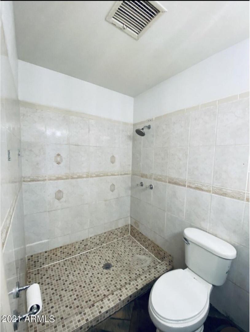 1522 East 9th Street Douglas, AZ 85607 - Photo 10 of 13 a bathroom with a toilet and shower