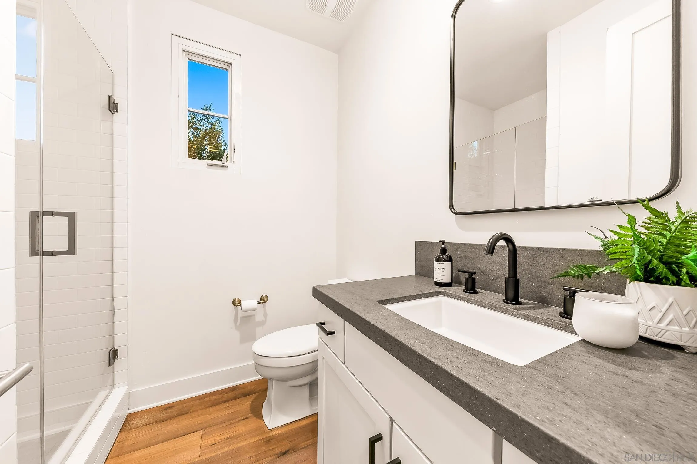 1245 Canton Court Encinitas, CA 92007 - Photo 57 of 71 a bathroom with a granite countertop sink and a mirror