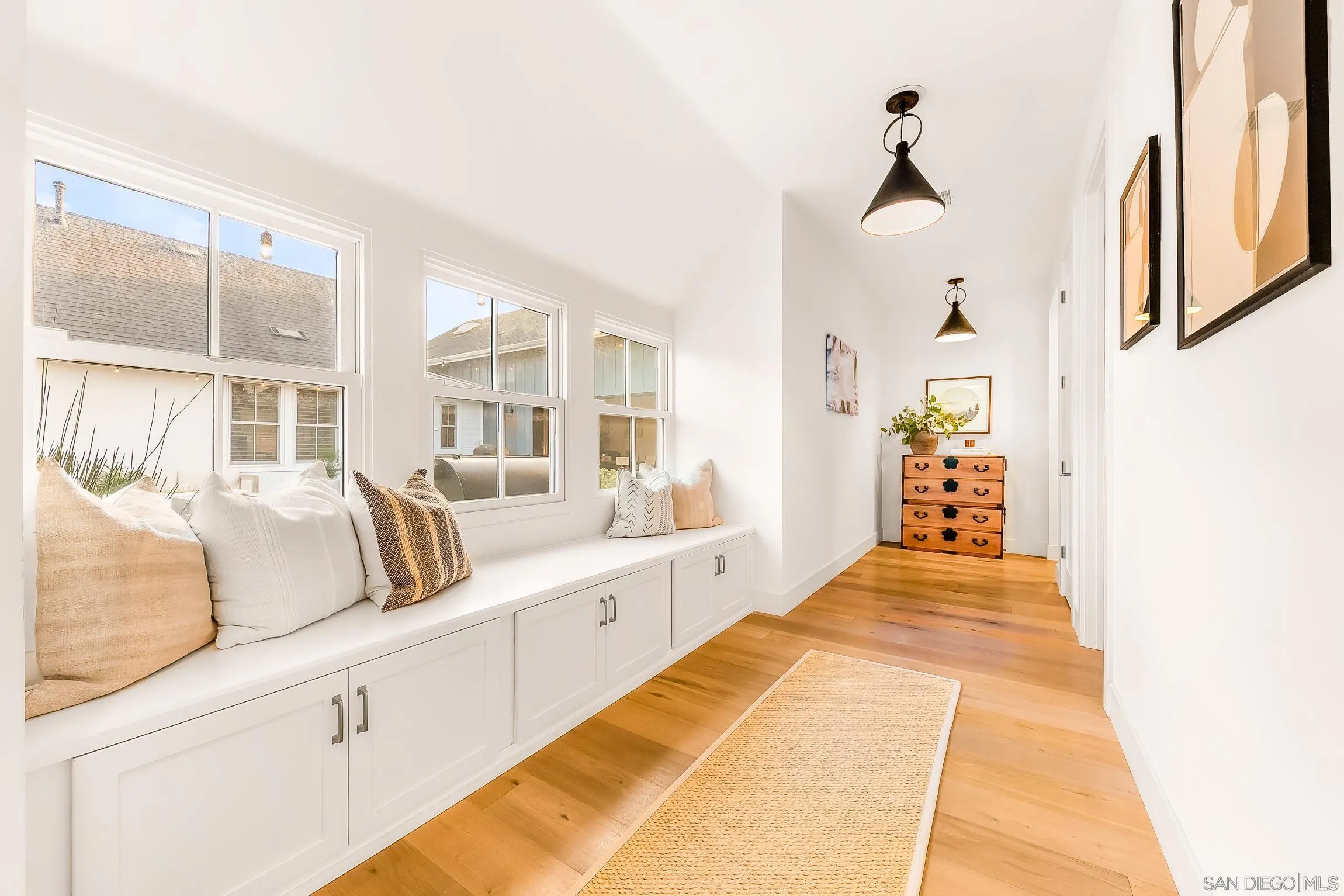 1245 Canton Court Encinitas, CA 92007 - Photo 67 of 71 a spacious bedroom with a large bed and a chandelier