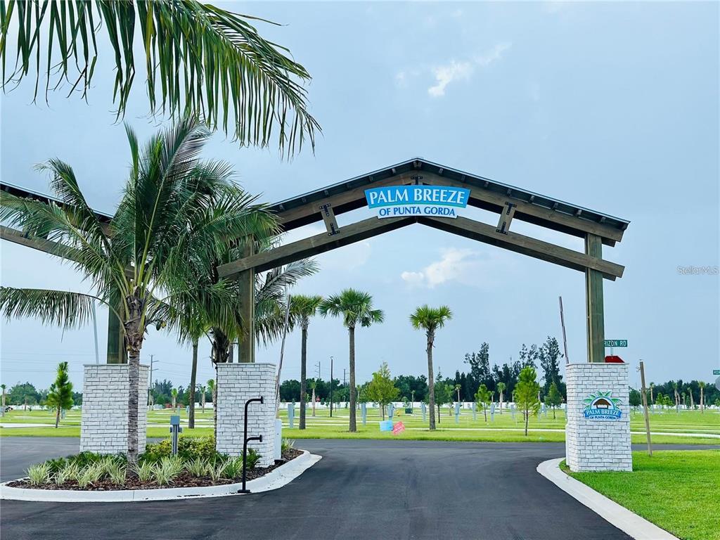 240 Horizon Road Punta Gorda, FL 33982 - Photo 2 of 21 a front view of multi story residential apartment building with a yard and palm trees