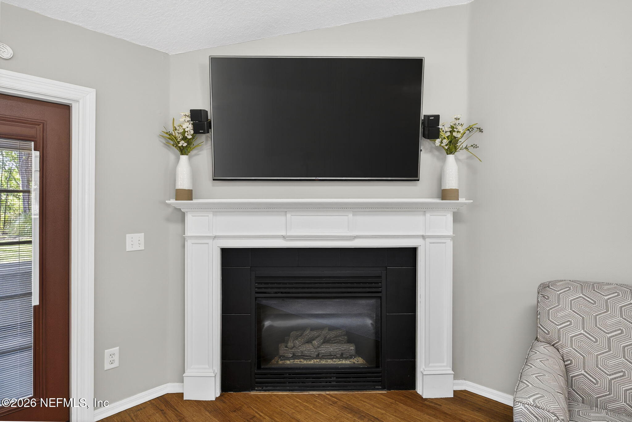 394 Cassandra Lane St. Augustine, FL 32086 - Photo 11 of 43 a living room with a fireplace and a flat screen tv
