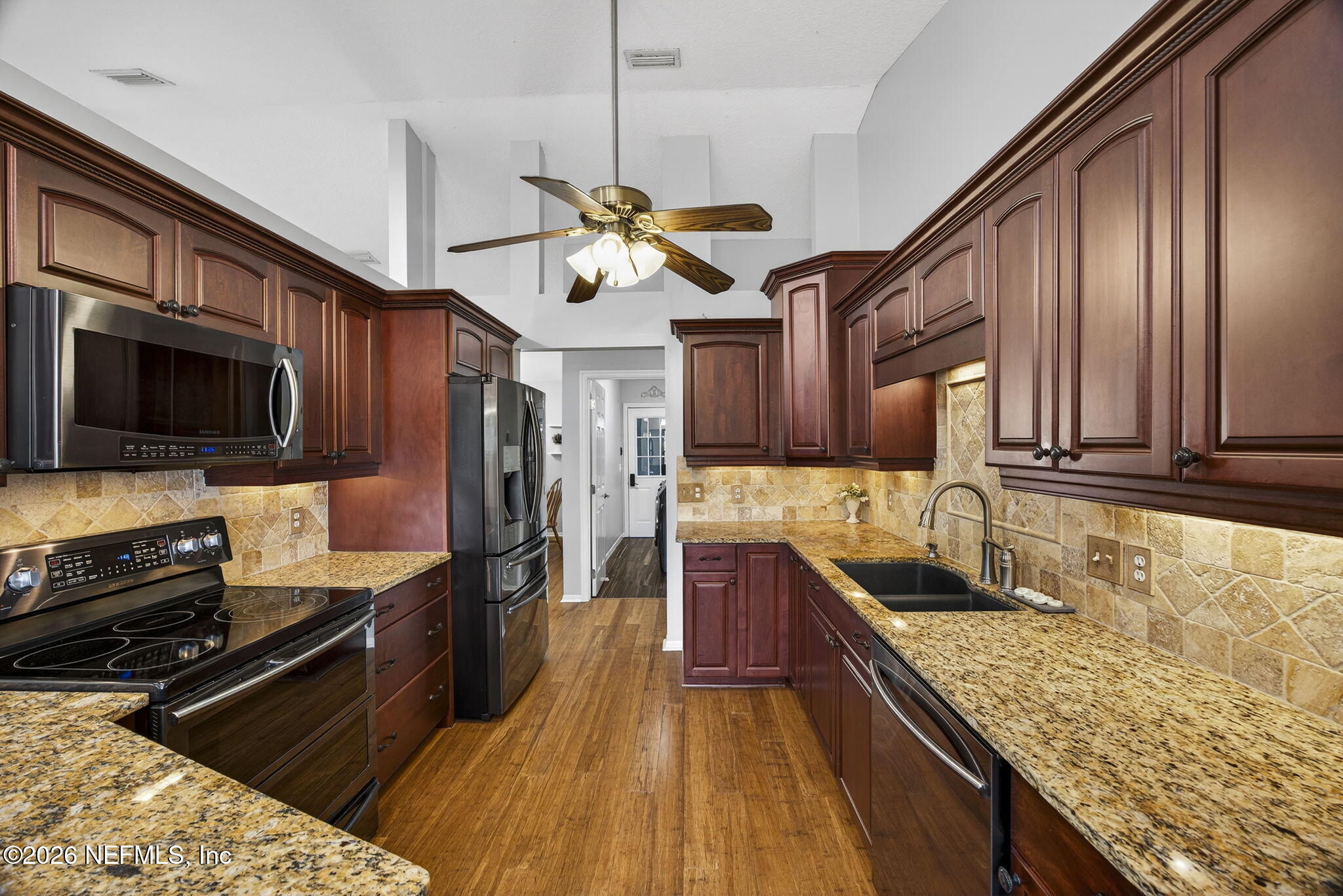 394 Cassandra Lane St. Augustine, FL 32086 - Photo 14 of 43 a kitchen with stainless steel appliances granite countertop a sink stove and refrigerator