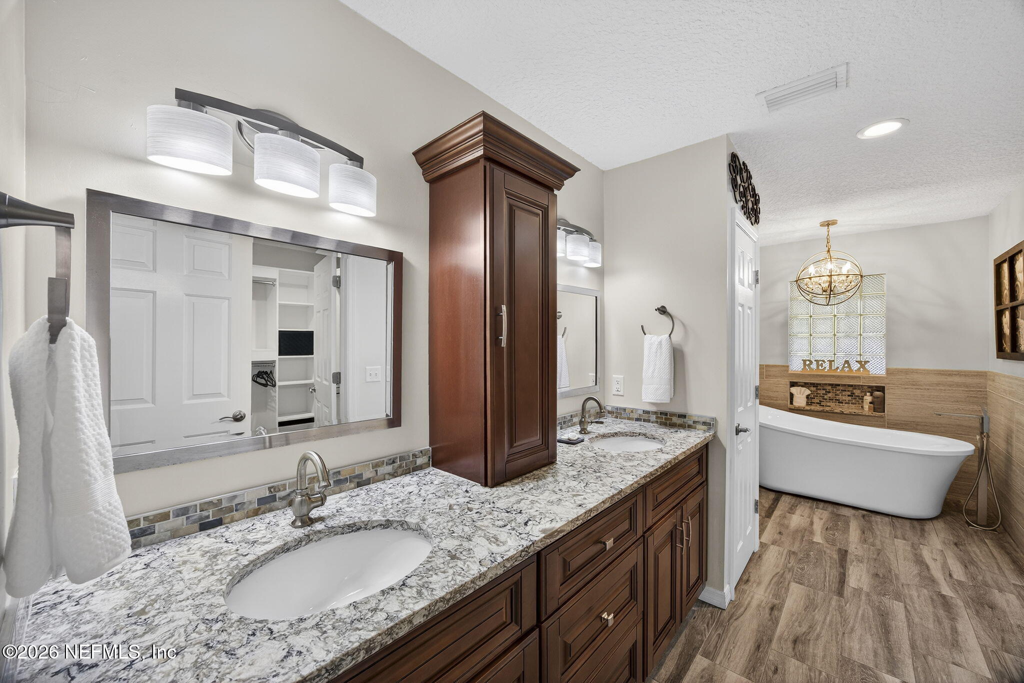 394 Cassandra Lane St. Augustine, FL 32086 - Photo 19 of 43 a spacious bathroom with a granite countertop sink a mirror and shower