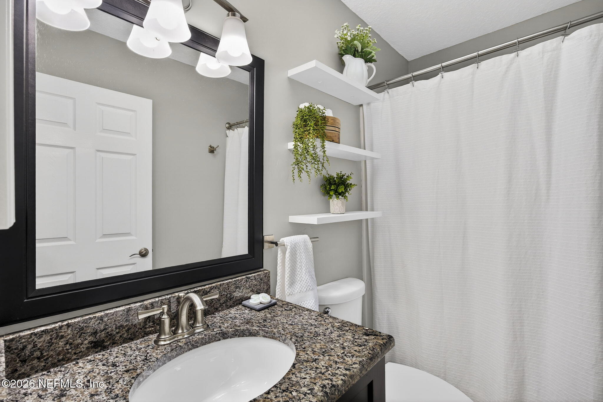 394 Cassandra Lane St. Augustine, FL 32086 - Photo 26 of 43 a bathroom with a granite countertop sink and a mirror