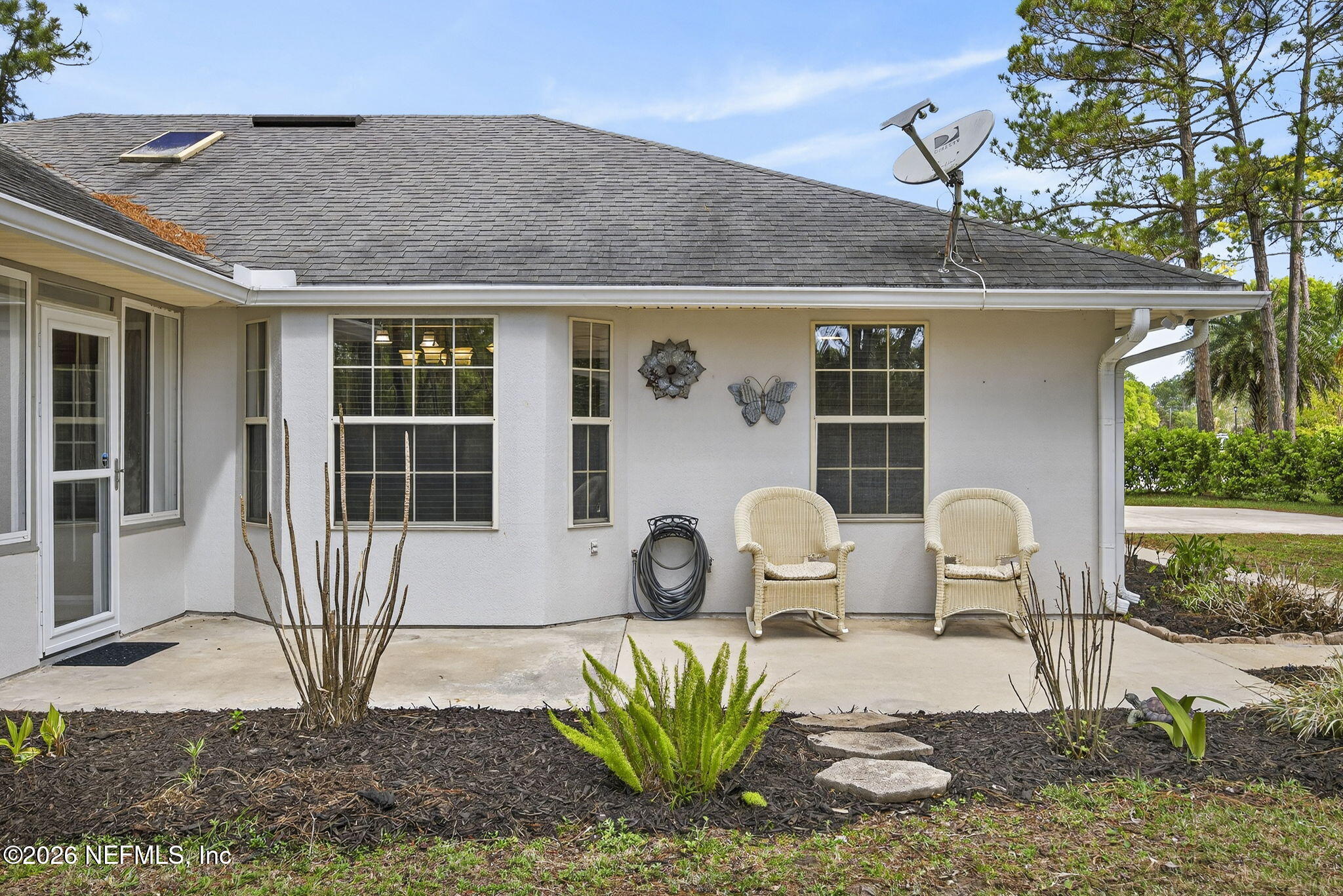 394 Cassandra Lane St. Augustine, FL 32086 - Photo 29 of 43 a view of a patio with table and chairs potted plants and large tree