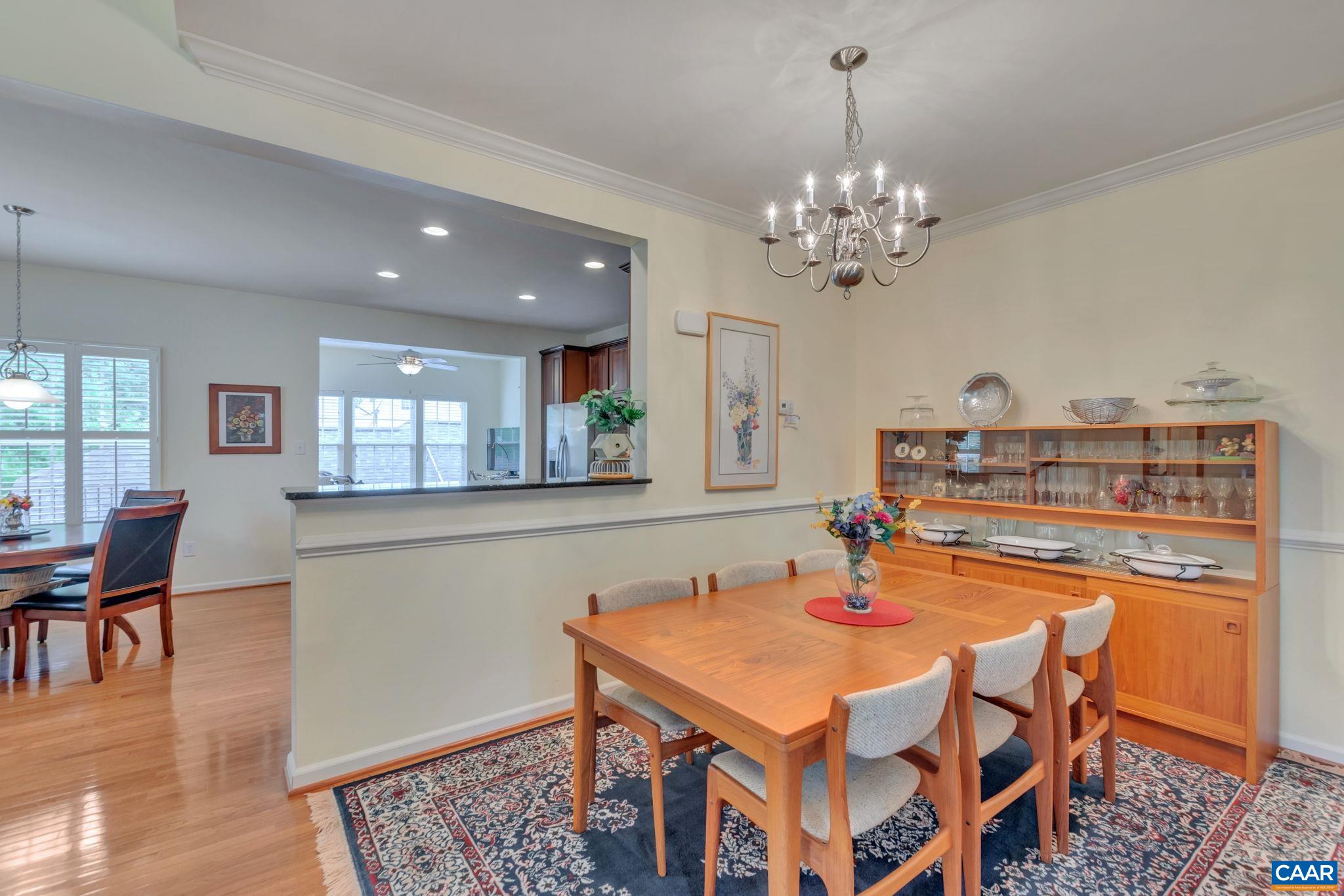 701 Rainier Road Charlottesville, VA 22903 - Photo 18 of 42 a dining room with furniture a chandelier and wooden floor