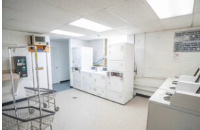 4240 North Clarendon Avenue, Unit 208S Chicago, IL 60613 - Photo 14 of 14 a living room with furniture and a table