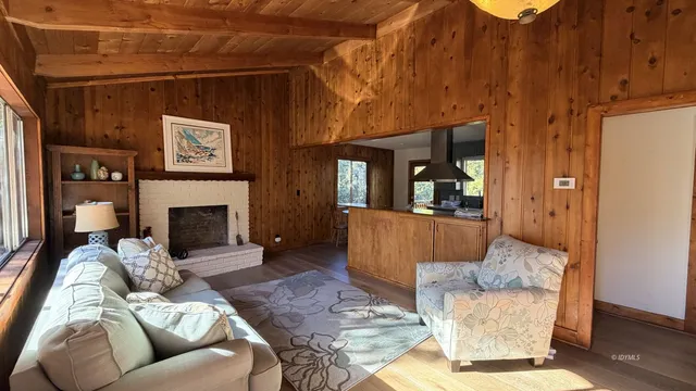 a living room with furniture a large window and a fireplace