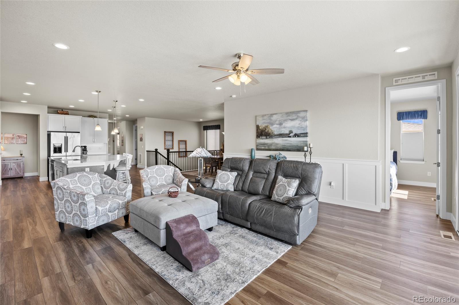164 Rockingham Circle Castle Pines, CO 80108 - Photo 11 of 43 a living room with furniture and wooden floor