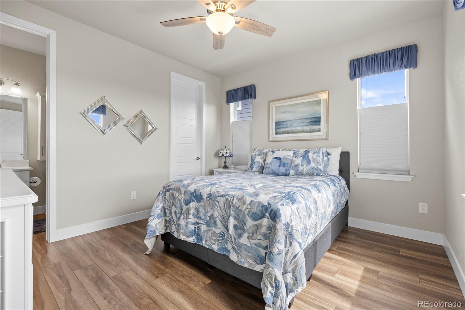 164 Rockingham Circle Castle Pines, CO 80108 - Photo 14 of 43 a bedroom with a bed and a chandelier