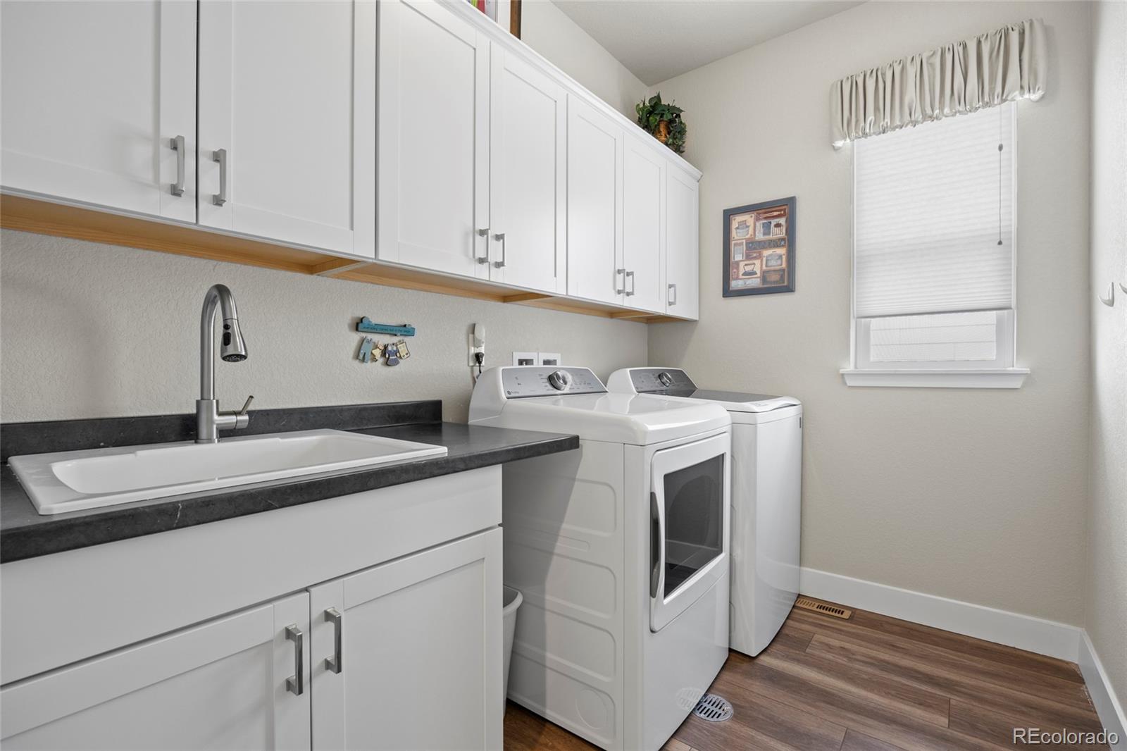 164 Rockingham Circle Castle Pines, CO 80108 - Photo 20 of 43 a utility room with sink dryer and washer