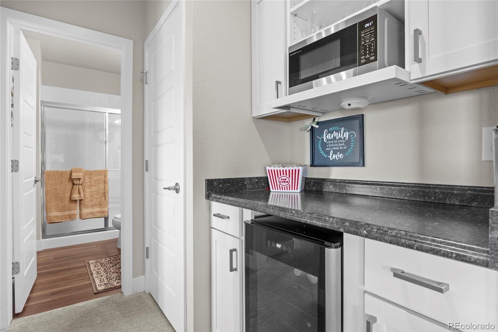164 Rockingham Circle Castle Pines, CO 80108 - Photo 25 of 43 a kitchen with stainless steel appliances granite countertop a sink and a microwave