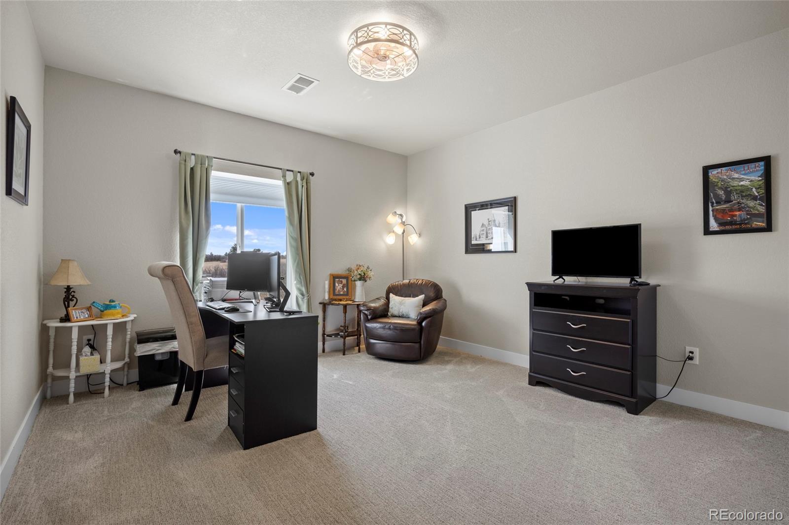 164 Rockingham Circle Castle Pines, CO 80108 - Photo 27 of 43 a view of a livingroom with furniture and a flat screen tv