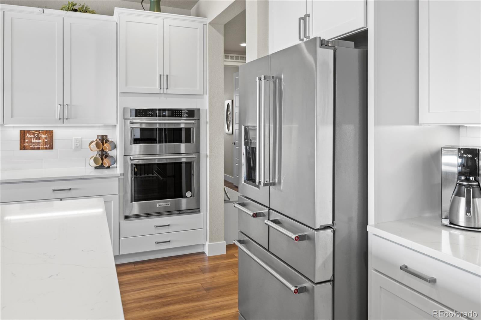 164 Rockingham Circle Castle Pines, CO 80108 - Photo 6 of 43 a kitchen with stainless steel appliances a refrigerator stove and cabinets