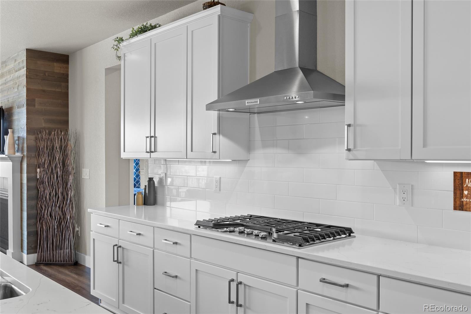 164 Rockingham Circle Castle Pines, CO 80108 - Photo 7 of 43 a kitchen with white cabinets and appliances