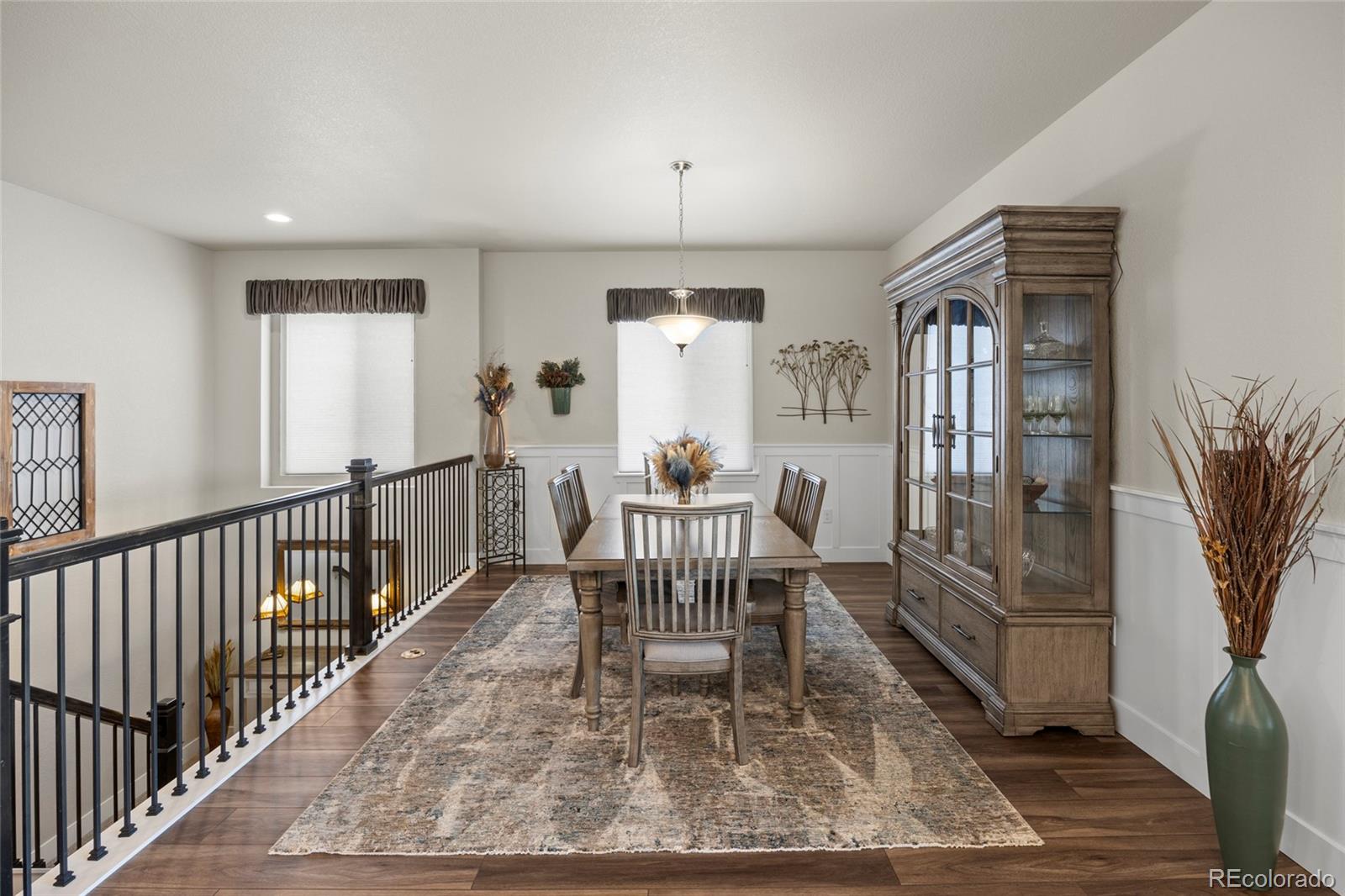 164 Rockingham Circle Castle Pines, CO 80108 - Photo 10 of 43 a dining room with furniture a chandelier and wooden floor