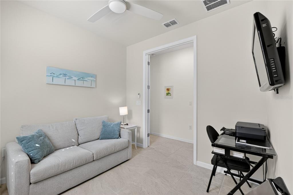 1319 Raspberry Dr Port North Port, FL 34289 - Photo 23 of 70 a living room with furniture a flat screen tv and a window