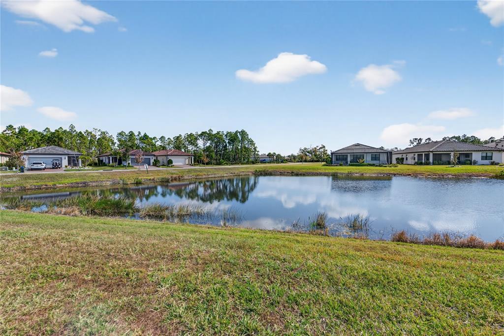 1319 Raspberry Dr Port North Port, FL 34289 - Photo 32 of 70 a view of a lake with houses in the back