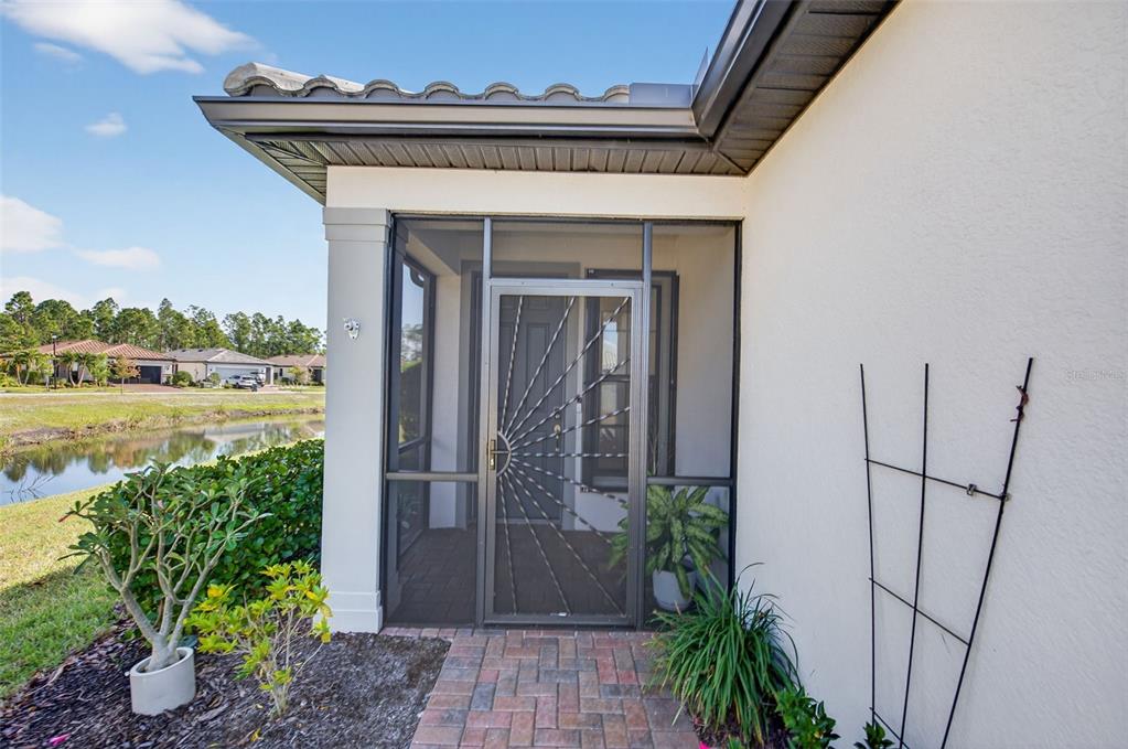 1319 Raspberry Dr Port North Port, FL 34289 - Photo 5 of 70 a view of a pathway of a house with a small yard and plants