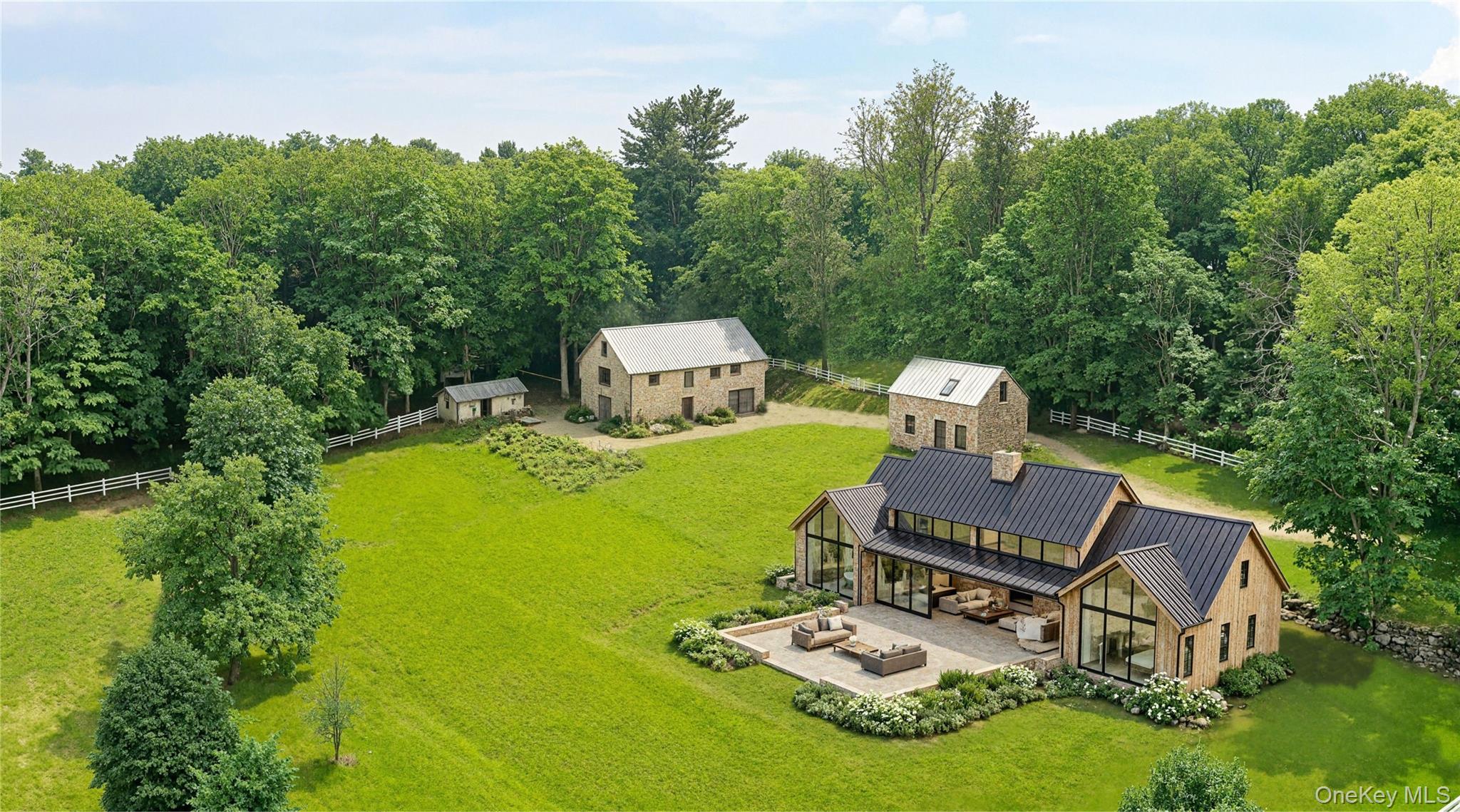 a view of a house with backyard sitting area and garden