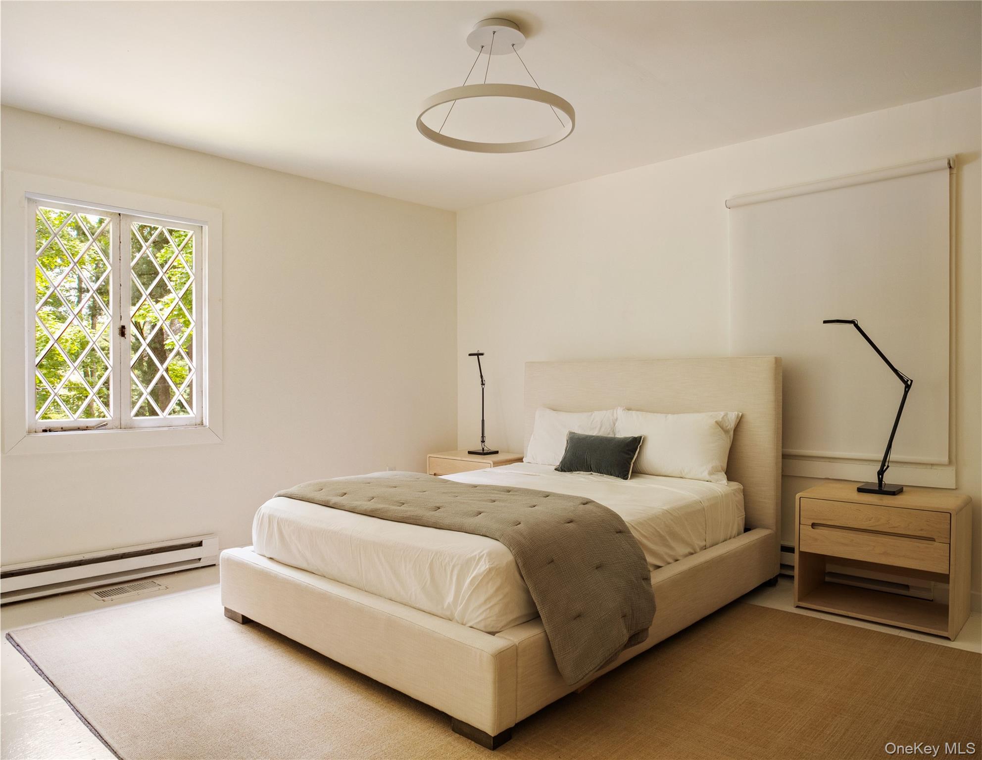 310 Mt Holly Road, Unit A Katonah, NY 10536 - Photo 17 of 33 a bedroom with a bed and lamp