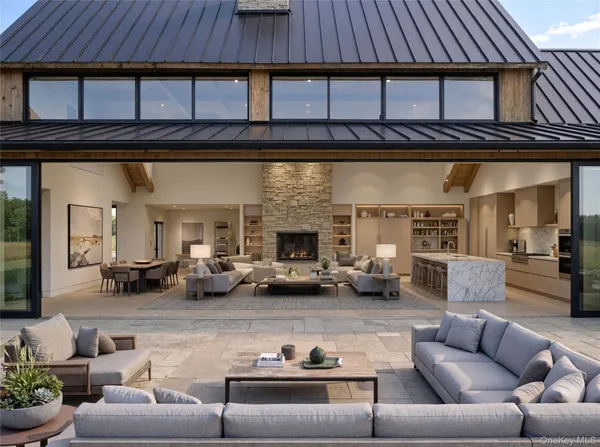 a living room with furniture a fireplace and kitchen view