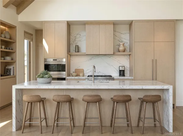 a kitchen with stainless steel appliances a sink and cabinets