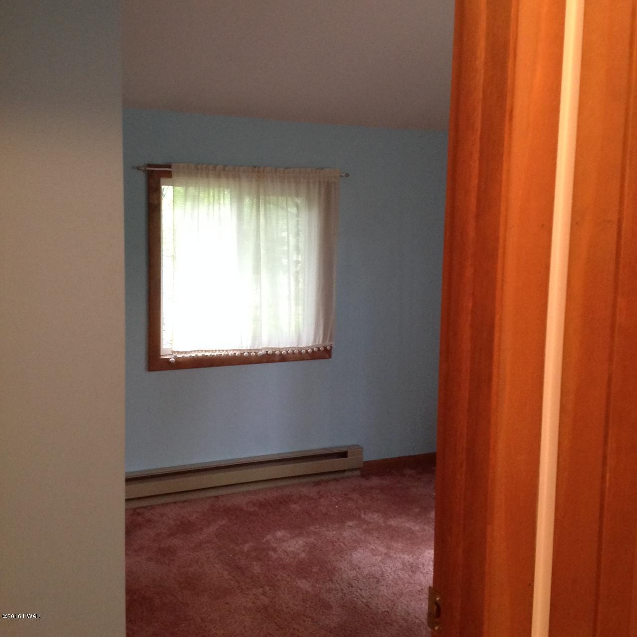 222 Maple Ridge Drive Hawley, PA 18428 - Photo 10 of 19 a view of an empty room with a window