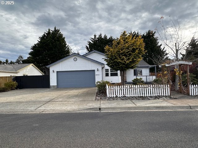 3932 Spruce Street Florence, OR 97439 - Photo 1 of 39 a front view of a house with a garage