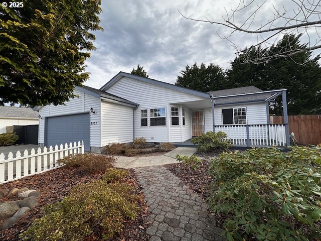 3932 Spruce Street Florence, OR 97439 - Photo 2 of 39 a front view of a house with garden