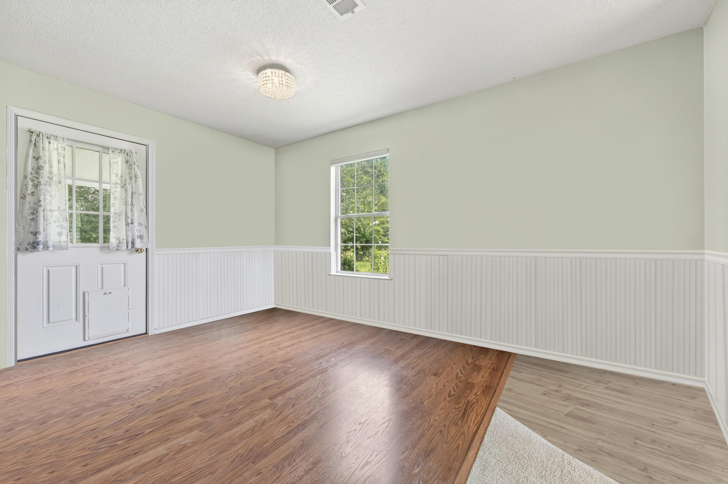 5589 Chalker Road Molino, FL 32577 - Photo 11 of 38 an empty room with wooden floor and windows