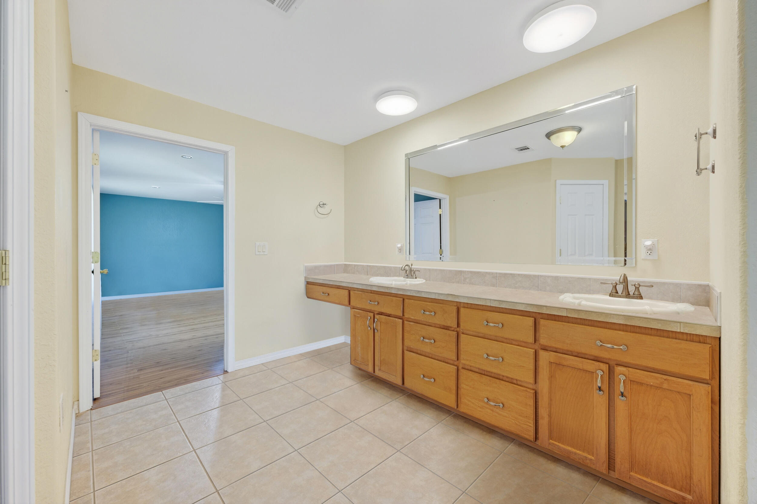 5589 Chalker Road Molino, FL 32577 - Photo 14 of 38 a spacious bathroom with a granite countertop sink a mirror and a
