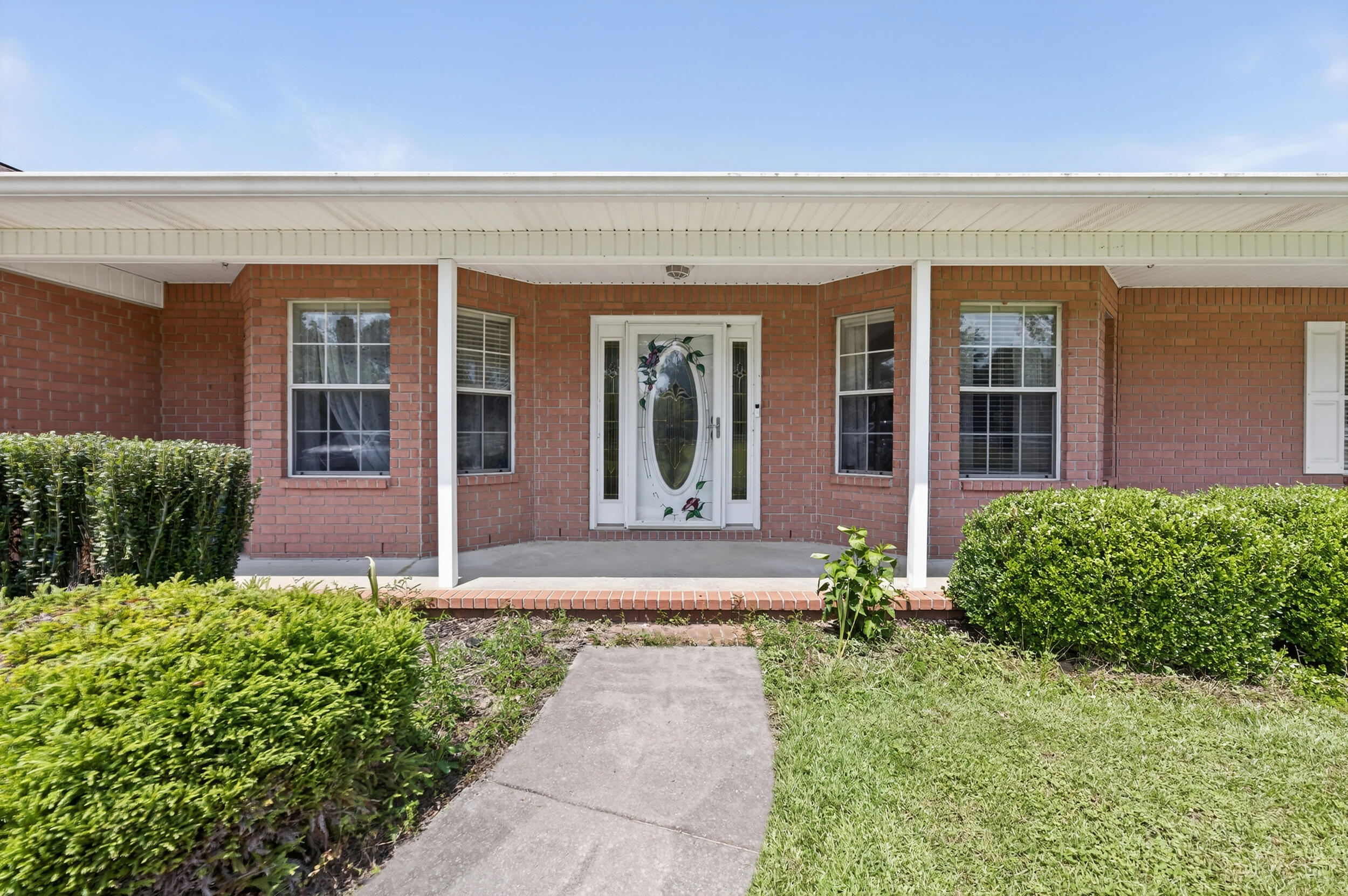 5589 Chalker Road Molino, FL 32577 - Photo 20 of 38 a front view of a house with garden
