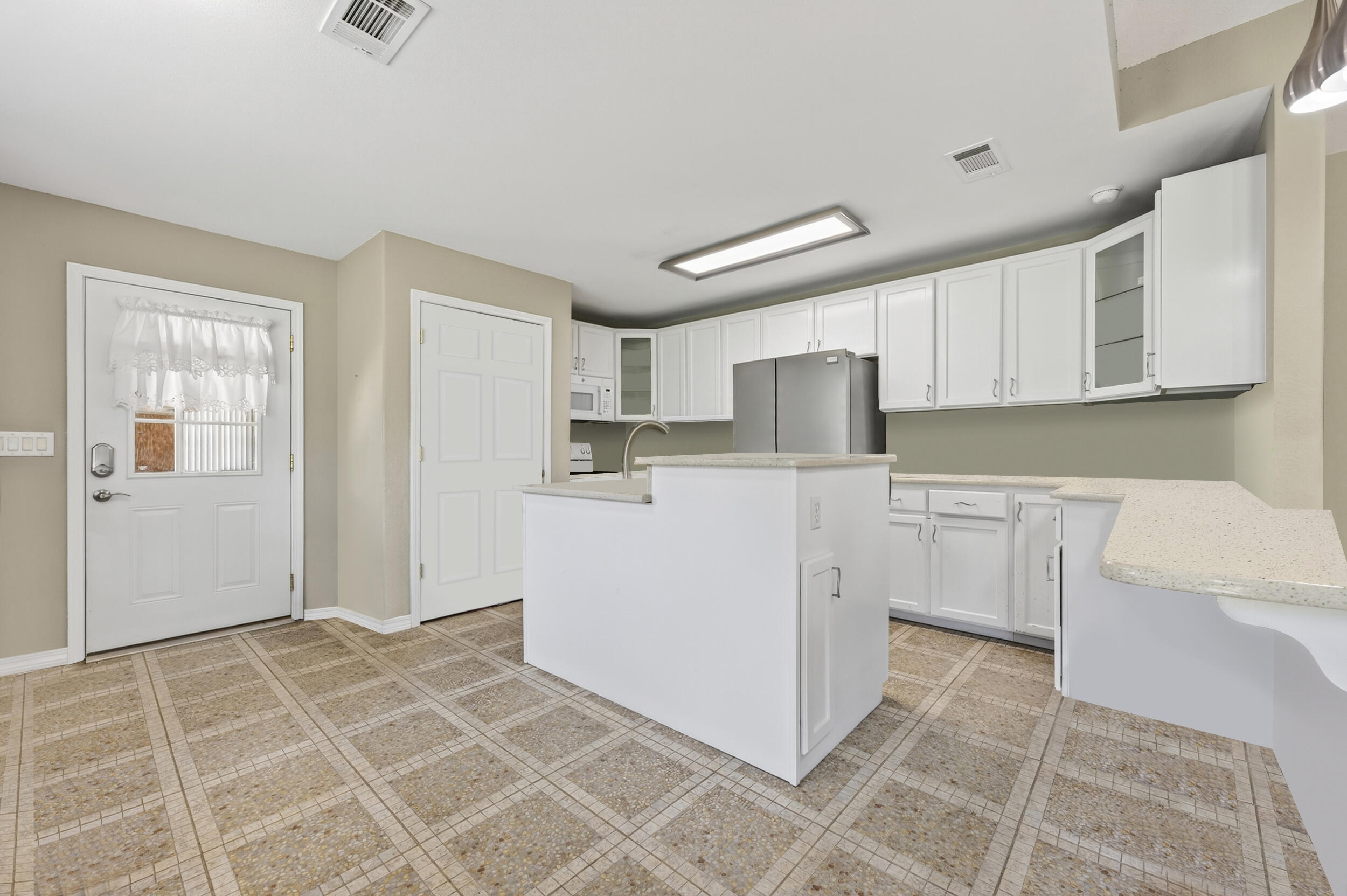5589 Chalker Road Molino, FL 32577 - Photo 3 of 38 a kitchen with cabinets and white appliances