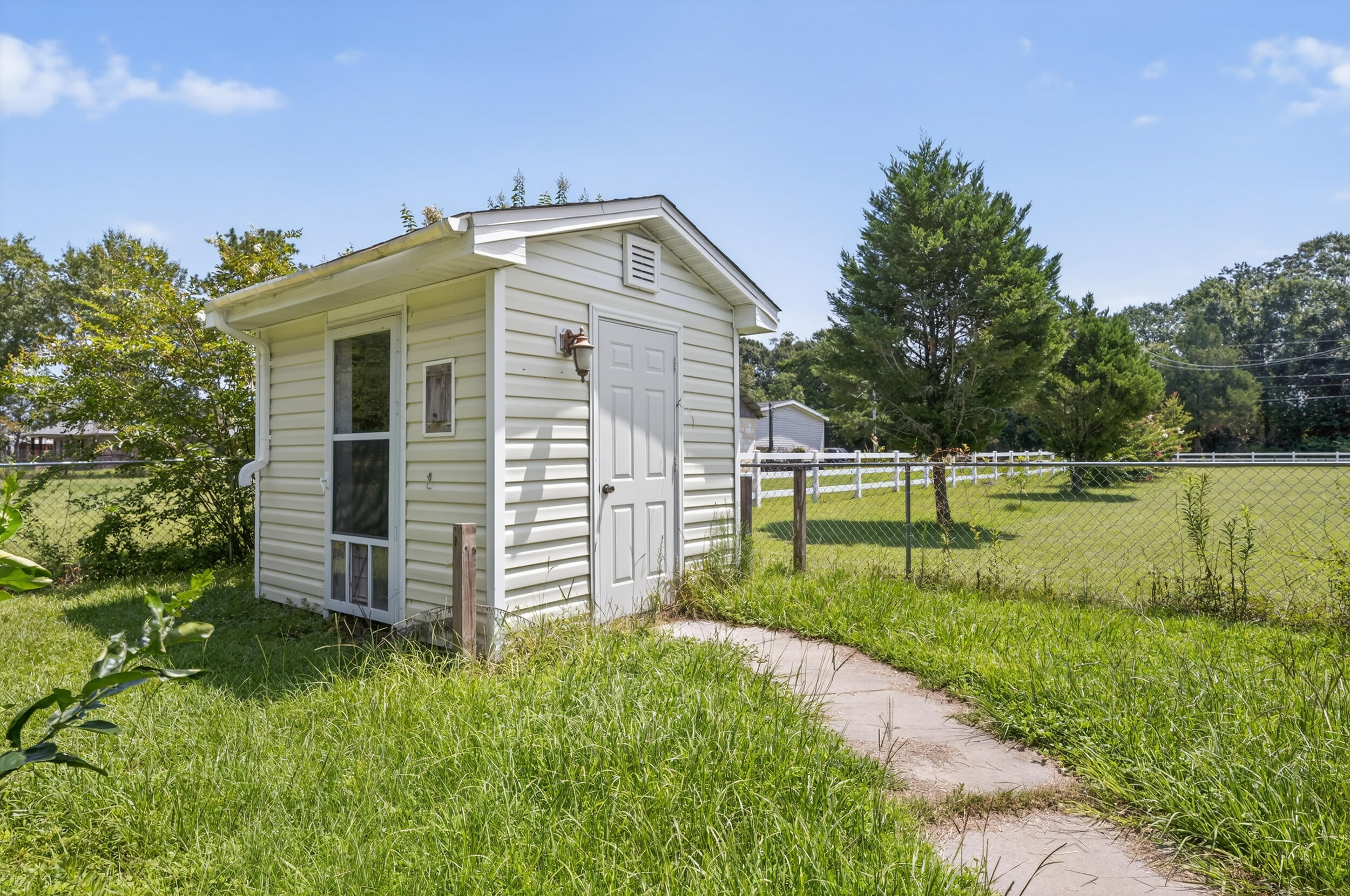 5589 Chalker Road Molino, FL 32577 - Photo 34 of 38 a view of a house with backyard and trees