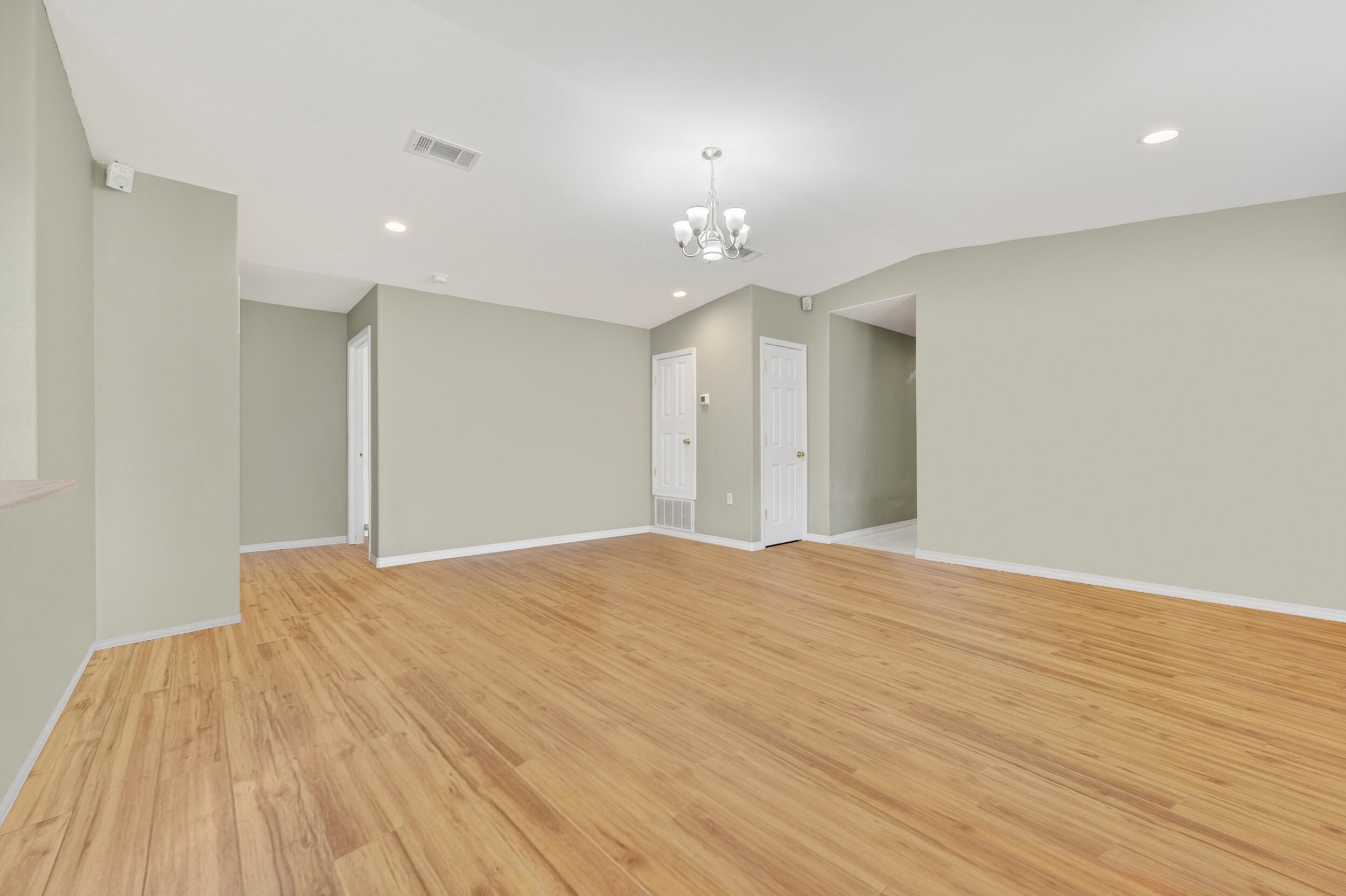5589 Chalker Road Molino, FL 32577 - Photo 8 of 38 a view of an empty room with wooden floor and a ceiling fan