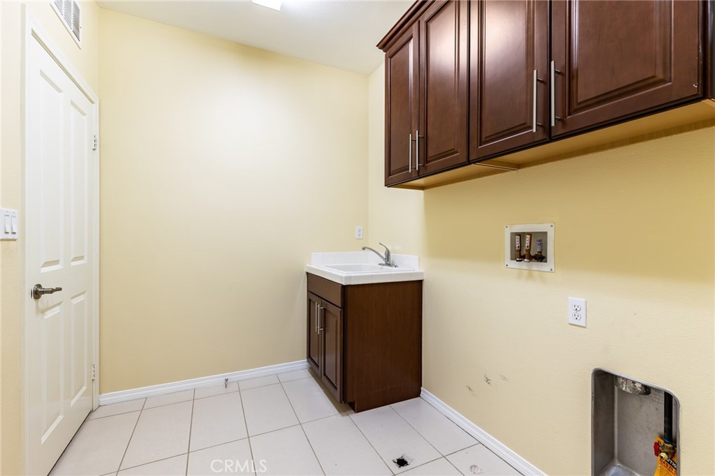 26459 Riverrock Way Saugus, CA 91350 - Photo 28 of 60 a kitchen with a refrigerator and cabinets