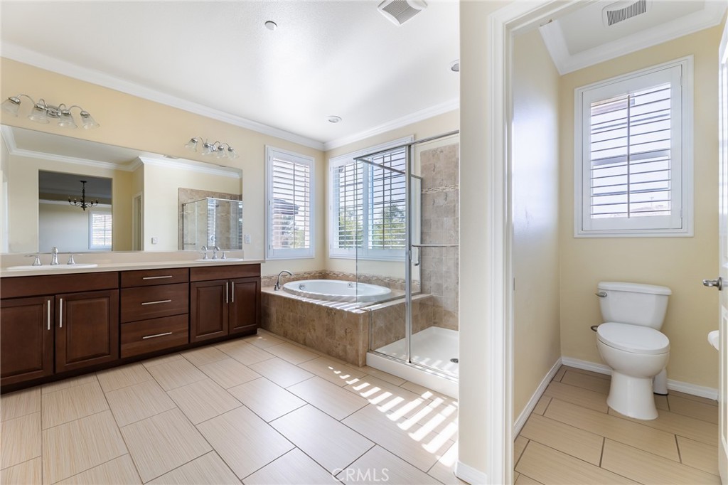 26459 Riverrock Way Saugus, CA 91350 - Photo 46 of 60 a bathroom with a granite countertop toilet sink and mirror