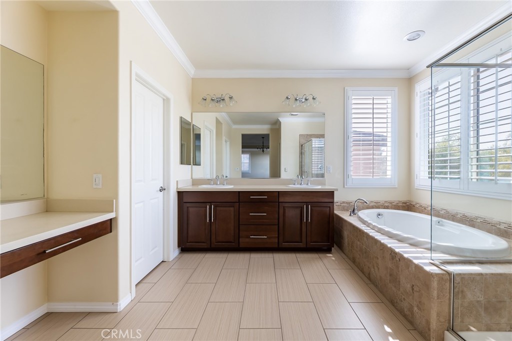 26459 Riverrock Way Saugus, CA 91350 - Photo 48 of 60 a spacious bathroom with a tub sink and mirror